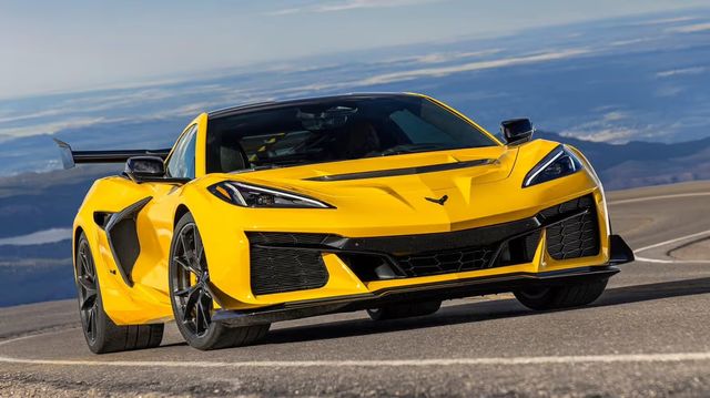 A yellow Corvette ZR1 on a mountain road under a blue sky