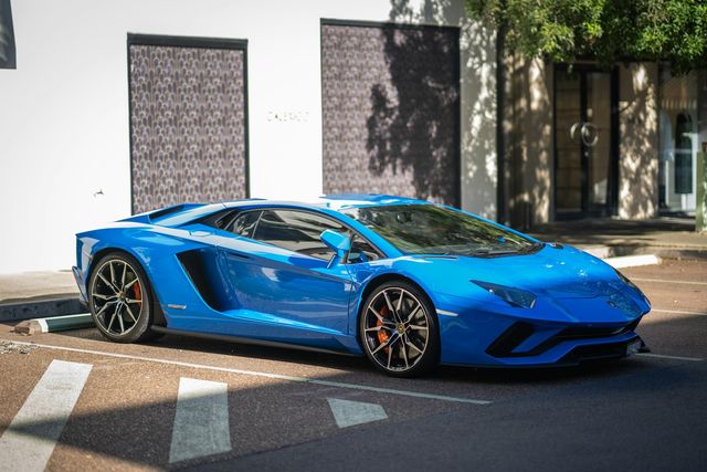 Supercars lined up in blue light